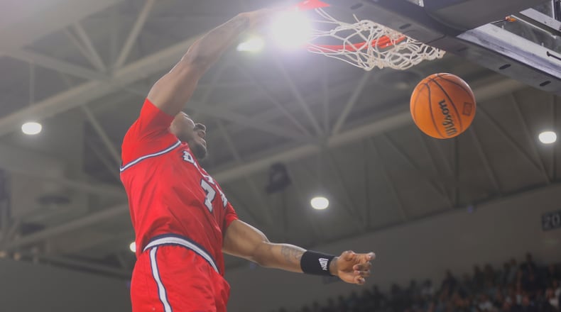 Dayton's Keonte Jones dunks against North Carolina Wilmington in the first round of the National Invitation Tournament on Saturday, March 21, 2026, at Trask Coliseum in Wilmington, N.C.. David Jablonski/Staff