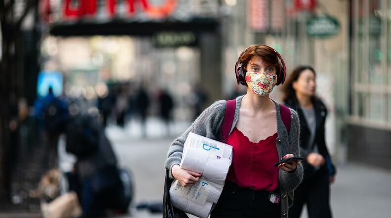 A woman wearing a protective mask on the street in New York City. (Jeenah Moon/Getty Images)