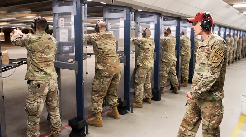 An 88th Security Forces Squadron combat arms instructor watches participants fire during the M18 9mm pistol Excellence in Competition shooting event held in May 2022 as part of Police Week at Wright-Patterson Air Force Base. U.S. AIR FORCE PHOTO/WESLEY FARNSWORTH