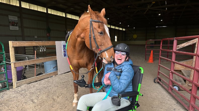 Students at the Therapeutic Riding Institute (TRI) work with horses. CONTRIBUTED