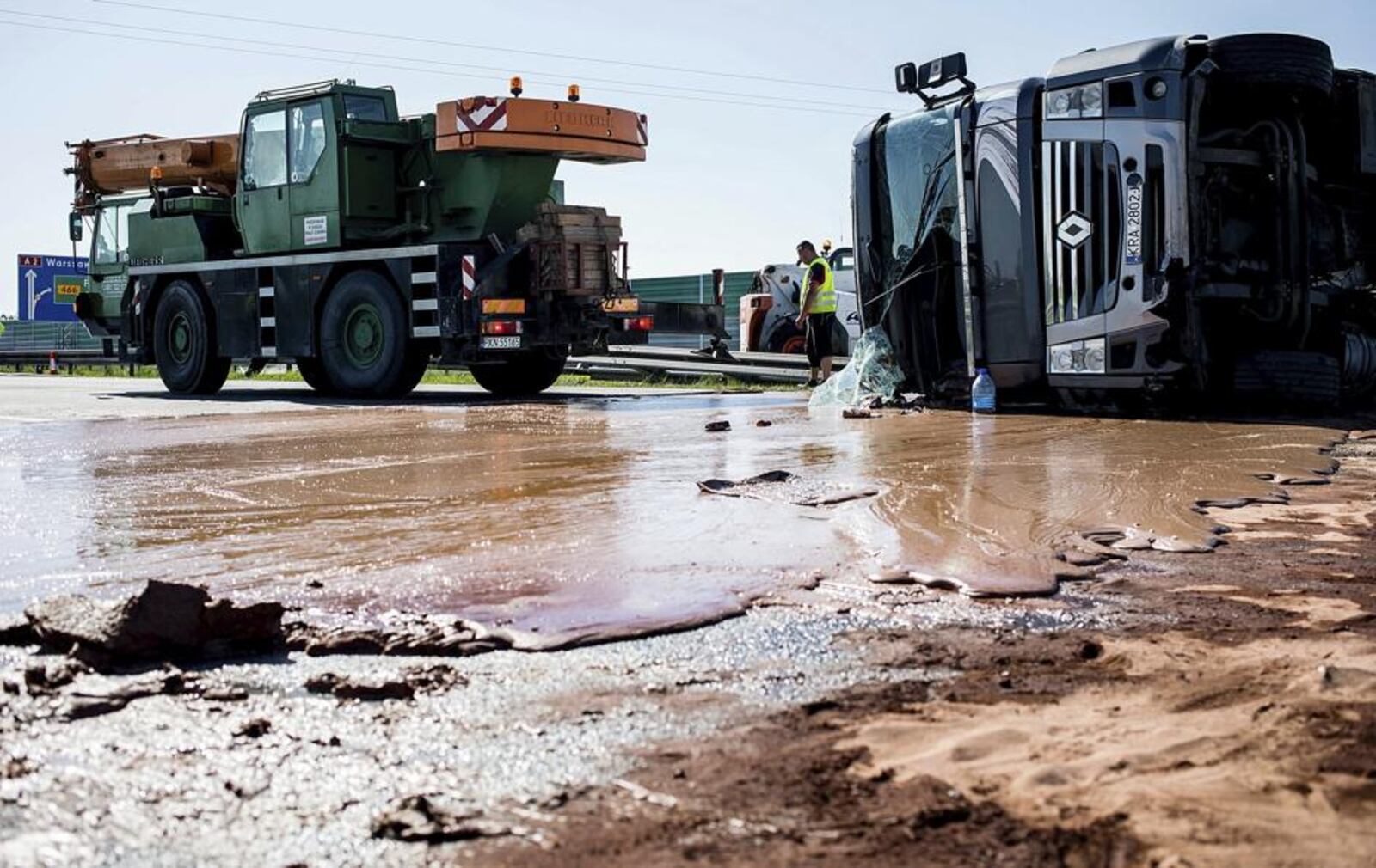 Tons of liquid milk chocolate are spilled and block six lanes on a highway after a truck transporting it overturned near Slupca, in western Poland, on Wednesday, May 9, 2018.