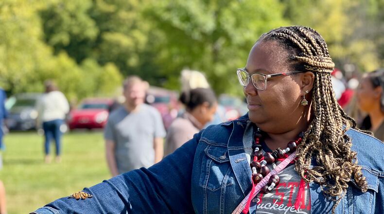 Juan Blanks lends an arm to a butterfly she released in honor of her late mother, Lynn, during an event hosted by Ohio's Hospice of Dayton on Saturday. AIMEE HANCOCK/STAFF