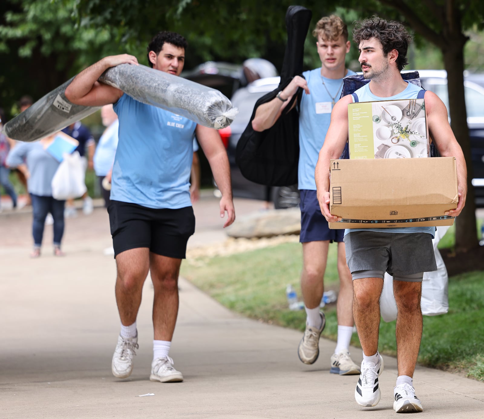 University of Dayton students who volunteered to help freshmen move in haul belongings on Friday, Aug. 22, in front of Marycrest Hall. The university is welcoming about 1,700 freshmen this weekend. BRYANT BILLING / STAFF