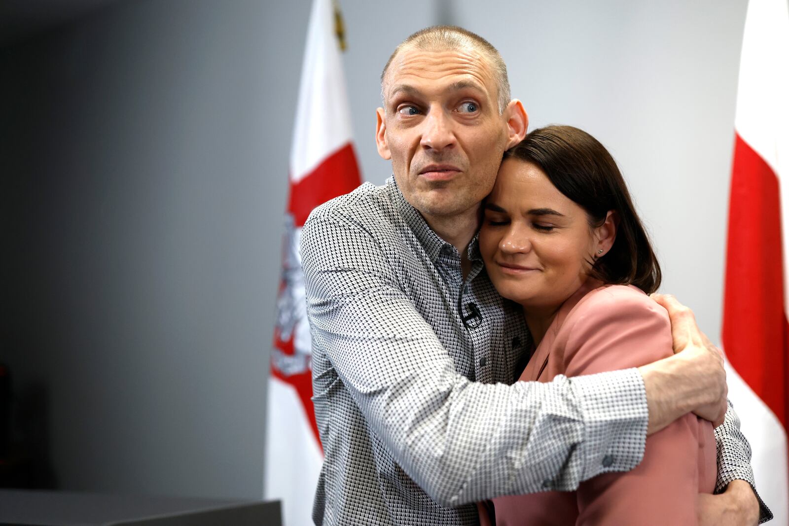 Syarhei Tsikhanouski, left, Belarusian opposition activist released from a Belarusian prison, embraces his wife, Belarusian opposition leader Sviatlana Tsikhanouskaya, after a news conference in Vilnius, Lithuania, Sunday, June 22, 2025. (AP Photo/Mindaugas Kulbis)