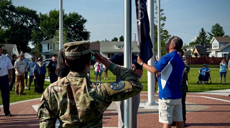 A Space Force guardian salutes towards the Space Force and American flags, as they are raised for the first time at Fairborn’s new Memorial Park. The dedication took place Thursday, July 3, 2025. CONTRIBUTED