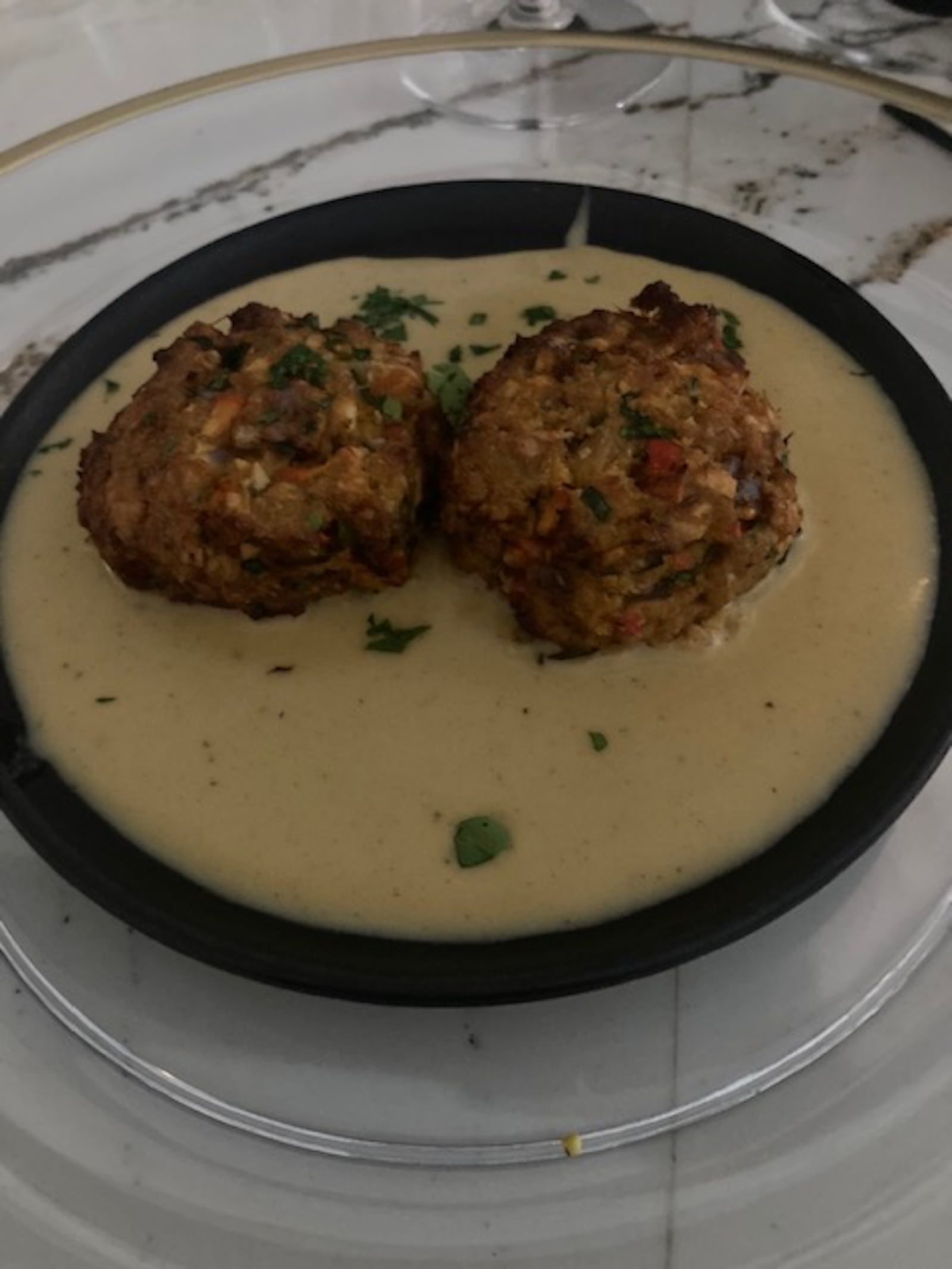 Petitte crab croquettes with sweet onion soubise at Meridien in Centerville. RAY MARCANO/CONTRIBUTED