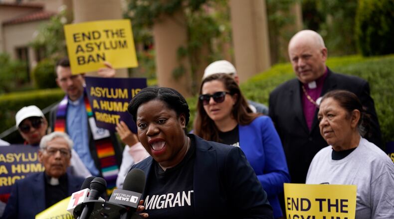 Guerline Jozef, Executive Director of the Haitian Bridge Alliance, speaks in front of demonstrators outside of the Richard H. Chambers U.S. Court of Appeals ahead of an asylum hearing, Tuesday, Nov. 7, 2023, in Pasadena, Calif. (AP Photo/Marcio Jose Sanchez)