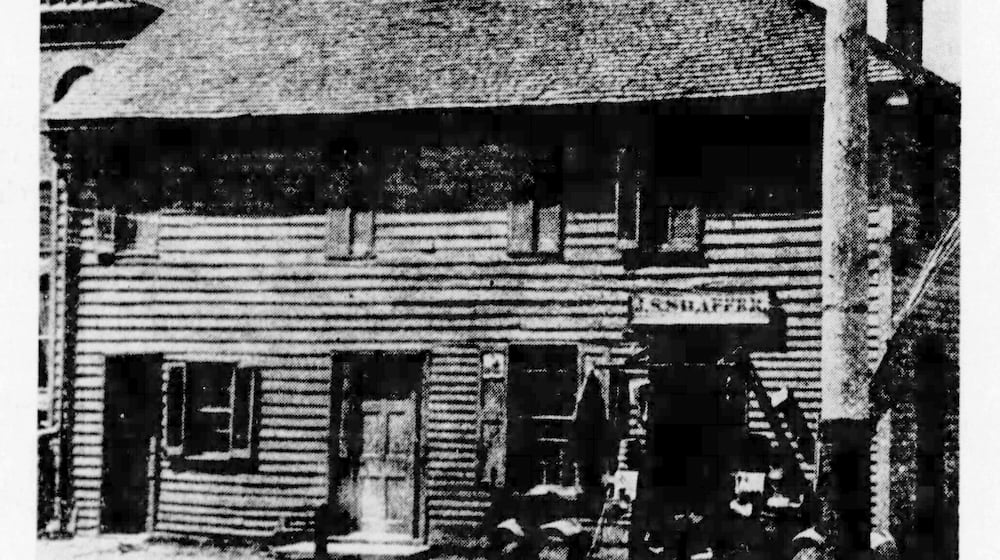 Historic Newcom Tavern, built in 1796, had its logs covered in this 1894 photograph.