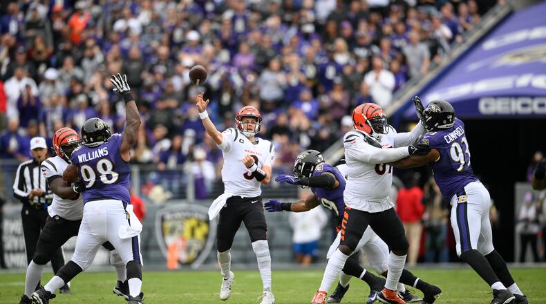 Cincinnati Bengals quarterback Joe Burrow, center, throws a pass against the Baltimore Ravens during the first half of an NFL football game, Sunday, Oct. 24, 2021, in Baltimore. (AP Photo/Nick Wass)