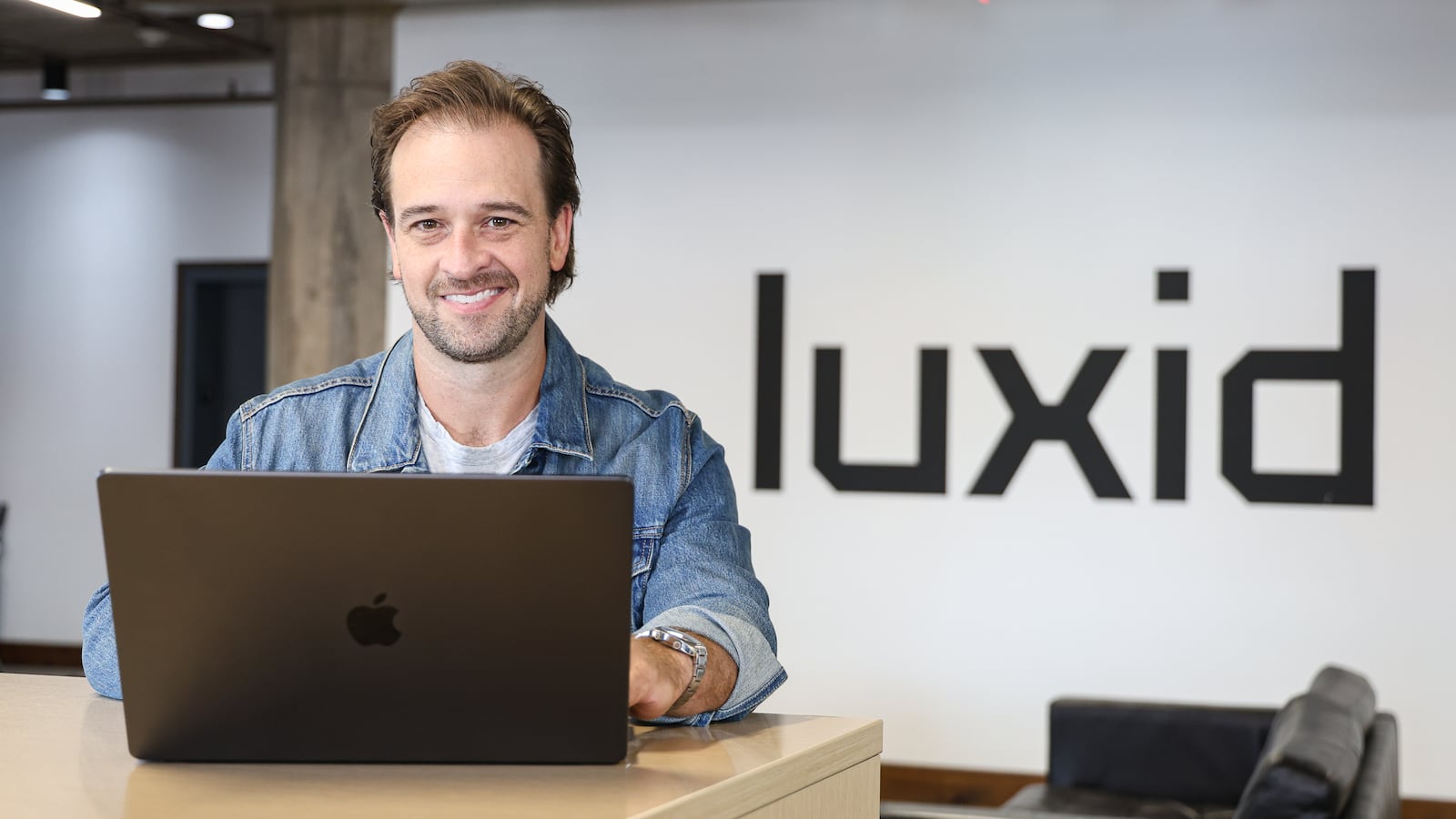Jonah Otchy, U.S. group creative director of Luxid, poses in the company's downtown Dayton office on Wednesday, Aug. 13. Otchy said the global firm is using AI tools to enhance talent, not replace it. BRYANT BILLING / STAFF