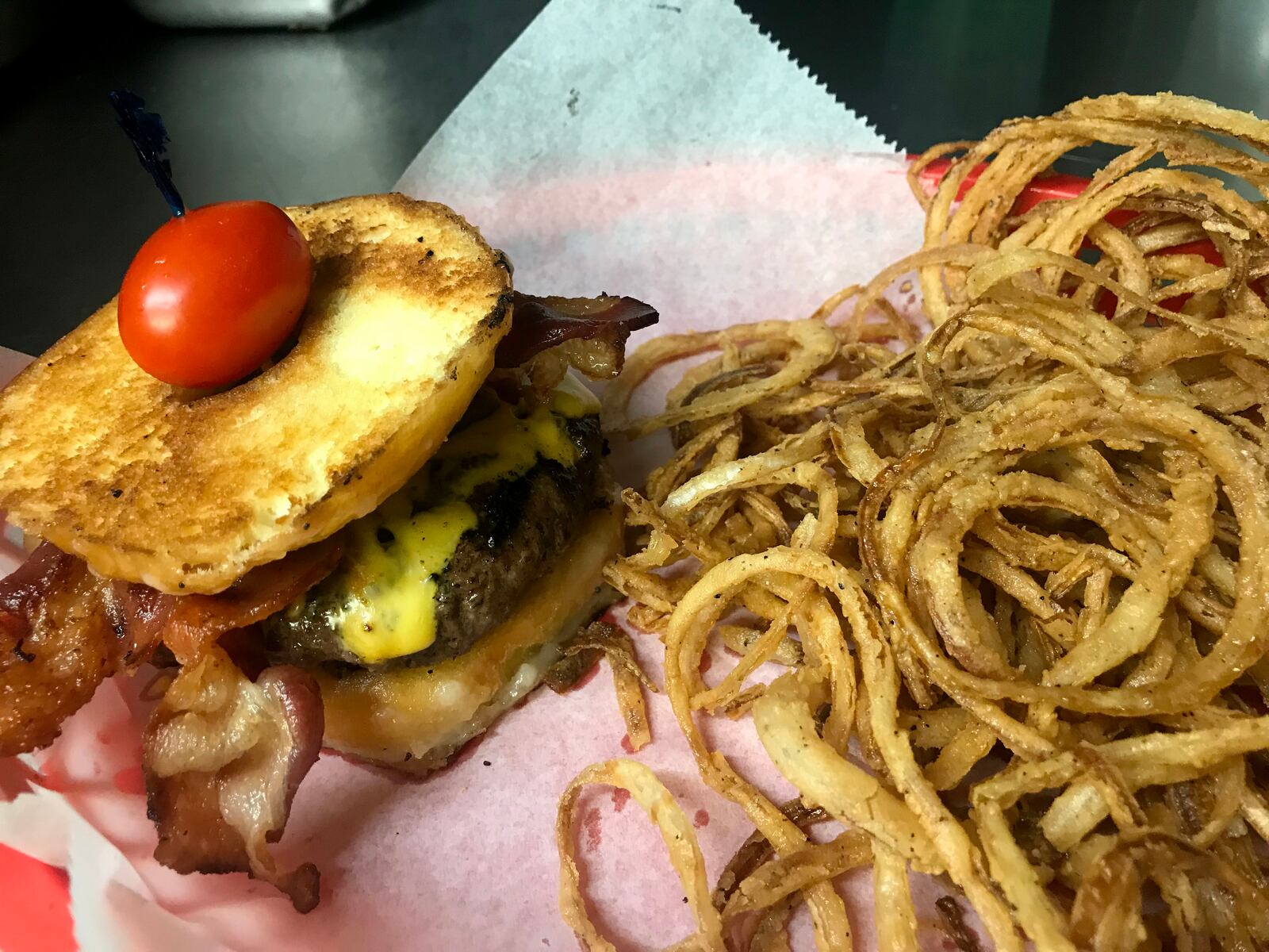 Buckin's Donkey's  Porky The Pig Doughnut Burger. Here is is served with house made onion rings.