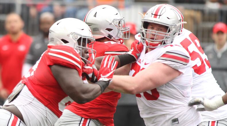 Ohio State’s Robert Landers, left, rushes against Brady Taylor during the spring game on Saturday, April 14, 2018, at Ohio Stadium in Columbus. Landers, a Wayne High School graduate, is one of several area players on the Buckeyes’ roster this season. David Jablonski/Staff