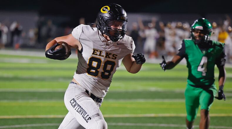 Centerville's Bryce Cowgill carries the ball into the end zone after catching a pass in open field against Northmont on Sept. 15, 2023. BILL LACKEY/STAFF
