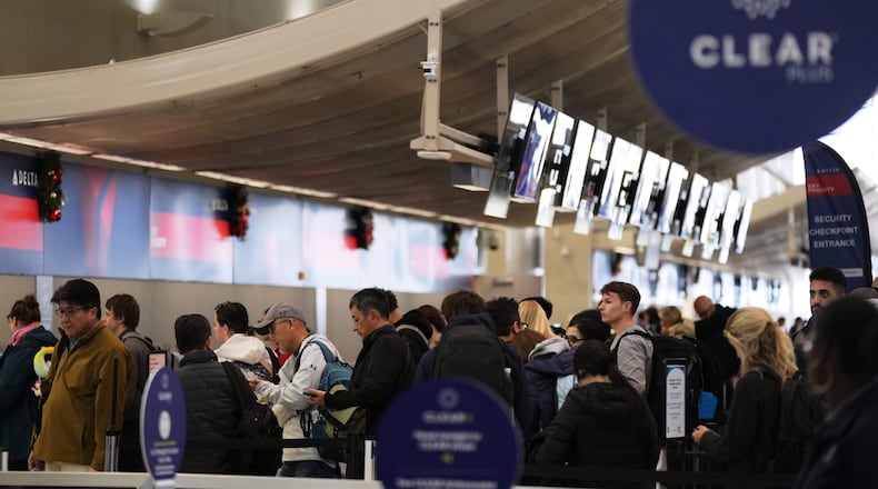 Travelers wait in a TSA checkpoint at Detroit Metropolitan Wayne County Airport Wednesday, Nov. 26, 2025, in Romulus, Mich. (AP Photo/Ryan Sun)