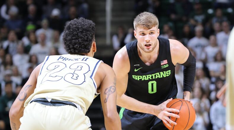 Michigan State’s Kyle Ahrens handles the ball against Charleston Southern’s Sean Price at the Breslin Center on November 18, 2019 in East Lansing, Michigan. (Photo by Rey Del Rio/Getty Images)