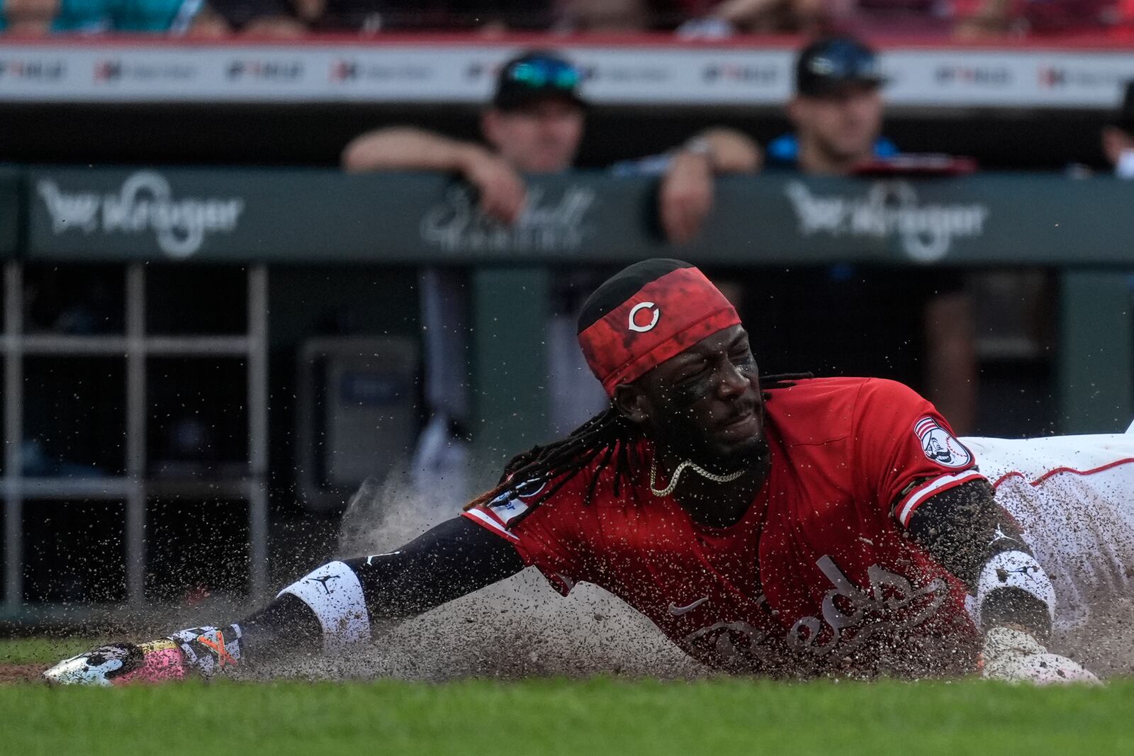 Cincinnati Reds' Elly De La Cruz slides safe at home plate to score on a single hit by Austin Hays during the sixth inning of a baseball game against the Miami Marlins in Cincinnati, Thursday, July 10, 2025. (AP Photo/Carolyn Kaster)