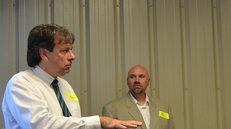 GP Caminiti (left), of Mitsubishi Electric Solar Innovations Division, and Ray Davis, president of OGW Energy Resources of Tipp City, talk to those touring the Shelby County Recycling Center to see technological improvements including a solar array system. CONTRIBUTED