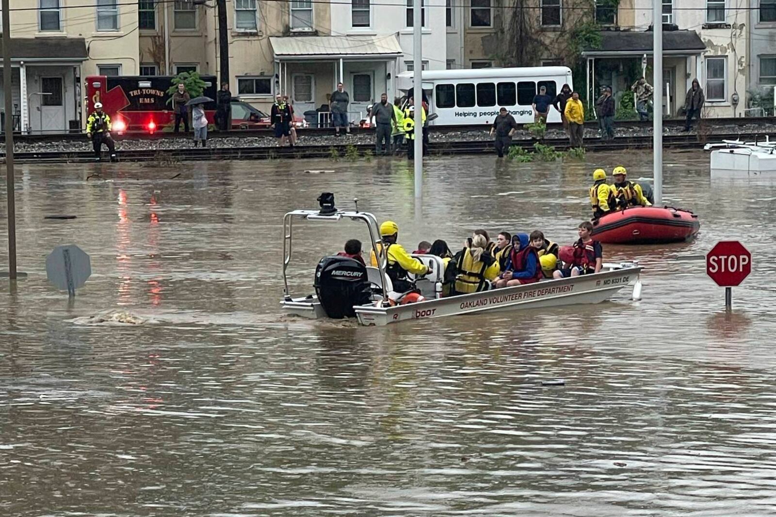 In a photo provided by Alley and Tim Wade, students are being rescued by boat after flash flooding in Westernport, MD., Tuesday, May 13, 2025. (Alley and Tim Wade via AP)