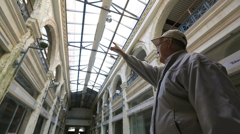 John Gower, CityWide’s urban design director, leads a tour through the Third Street arcade section of the Dayton Arcade. FILE