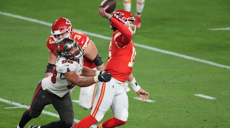 Kansas City Chiefs quarterback Patrick Mahomes (15) tries to pass as Tampa Bay Buccaneers outside linebacker Anthony Nelson (98) grabs him from behind in the second quarter of Super Bowl LV at Raymond James Stadium in Tampa, Fla., Feb. 7, 2021. (Chang W. Lee/The New York Times)