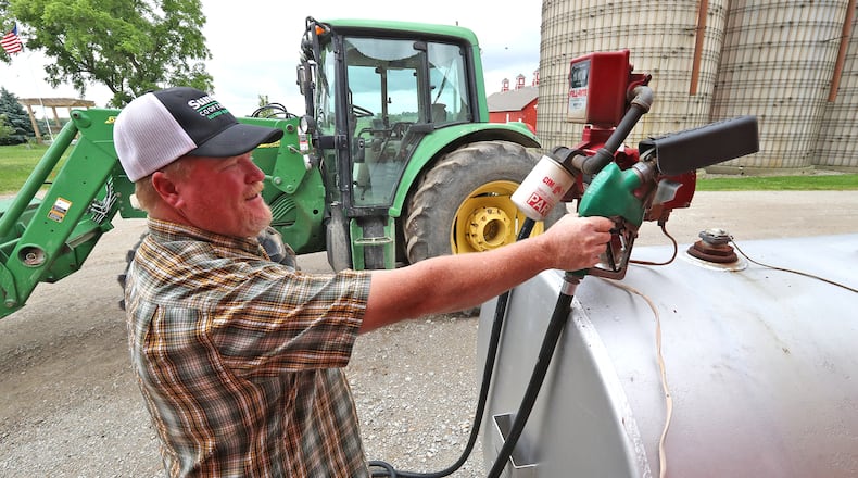 Brian Harbage fuels up one of his tractors Thursday, June 9, 2022 on his farm near South Charleston. BILL LACKEY/STAFF
