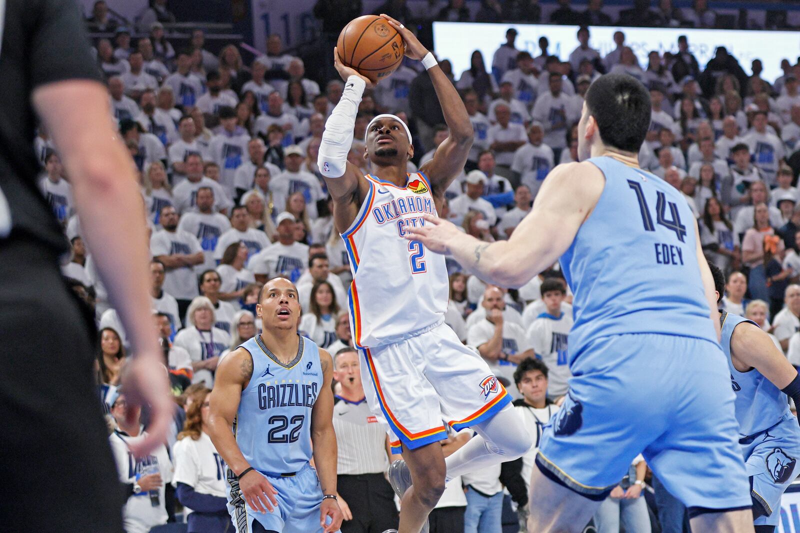 Oklahoma City Thunder guard Shai Gilgeous-Alexander (2) looks to shoot between Memphis Grizzlies guard Desmond Bane (22) and center Zach Edey (14) during the first half in Game 1 of an NBA first-round playoff series, Sunday, April 20, 2025, in Oklahoma City. (AP Photo/Nate Billings)