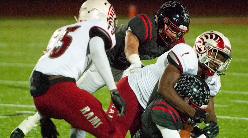 Trotwood’s defense swarms a ball carrier during its Division III state semifinal against Columbus Bishop Hartley on Friday at London High School. Jeff Gilbert/CONTRIBUTED