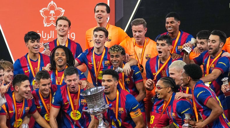 Barcelona players celebrate after winning the Spanish Super Cup final soccer match against Real Madrid at King Abdullah Sports City Stadium in Jeddah, Saudi Arabia, Sunday, Jan. 11, 2026. (AP Photo/Altaf Qadri)