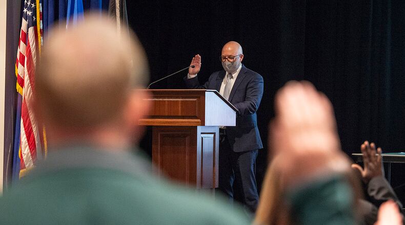 Gregory Leingang, 88th Air Base Wing vice director, leads new civilian hires in the oath of office April 26 at Wright-Patterson Air Force Base. Article 6 of the Constitution requires an oath by all federal and state government officials, including Department of Defense civilian and military personnel. U.S. AIR FORCE PHOTO/WESLEY FARNSWORTH