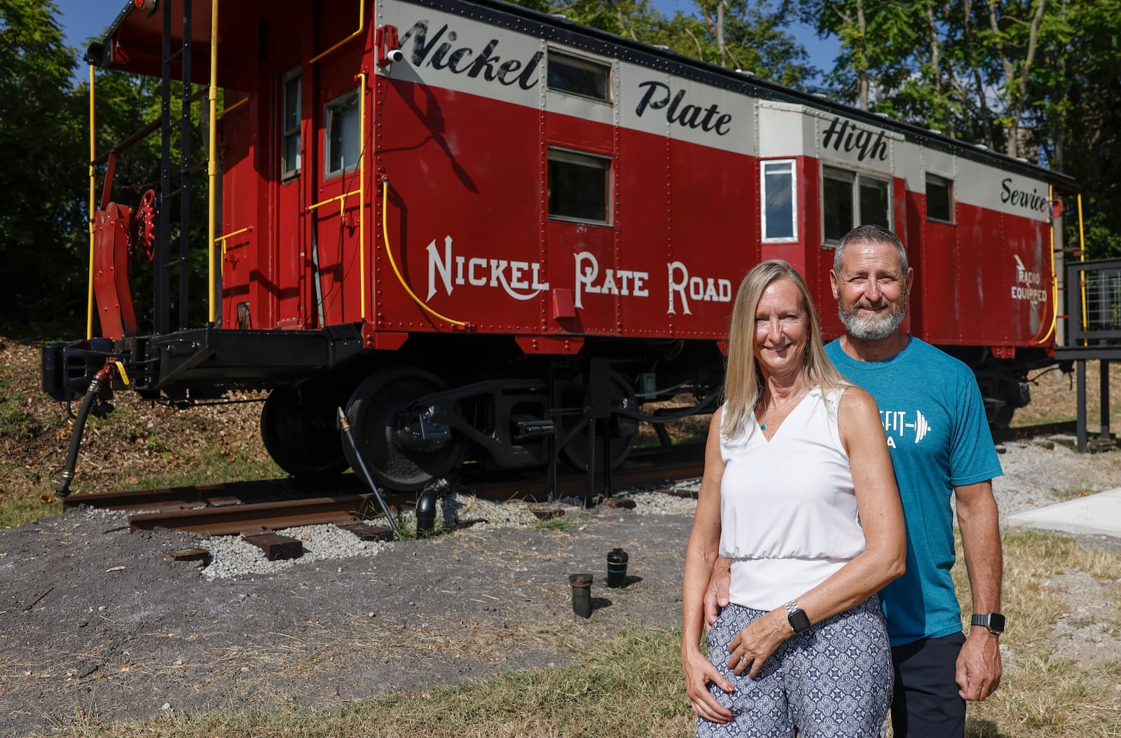 Ray and Karen DeVite pose for a portrait outside one of their cabooses they turned into an Airbnb on Monday, September 15, 2025, in Xenia. JOSEPH COOKE/STAFF