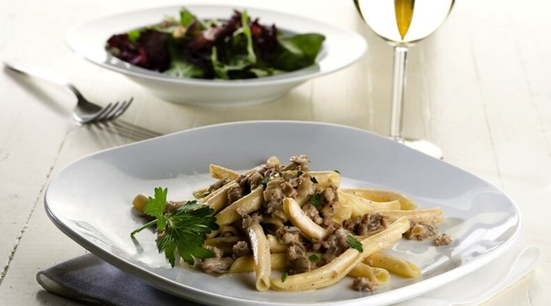 Strangozzi pasta, a shape tied to the Italian region of Umbria, is dressed with a rich sauce of sausage, truffle paste and cream. (Chicago Tribune)
