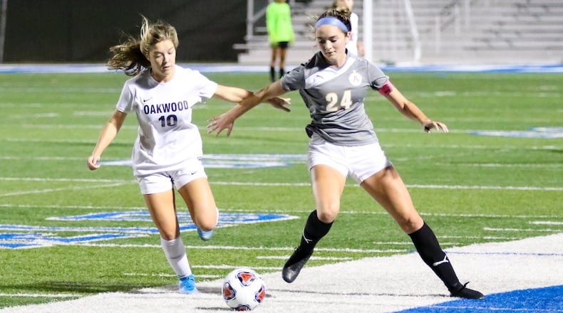 Alter High School’s Lauren Schimpf and Oakwood’s Riley Beam tussle for the ball during their match on Tuesday night at Miamisburg’s Holland Field. The Knights won 3-0. CONTRIBUTED PHOTO BY MICHAEL COOPER