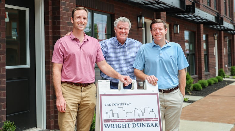From left to right, Crosby Simms, Charles Simms and Robi Simms in front of townhomes at the Townes at Wright-Dunbar, which has 26 units. BRYANT BILLING / STAFF