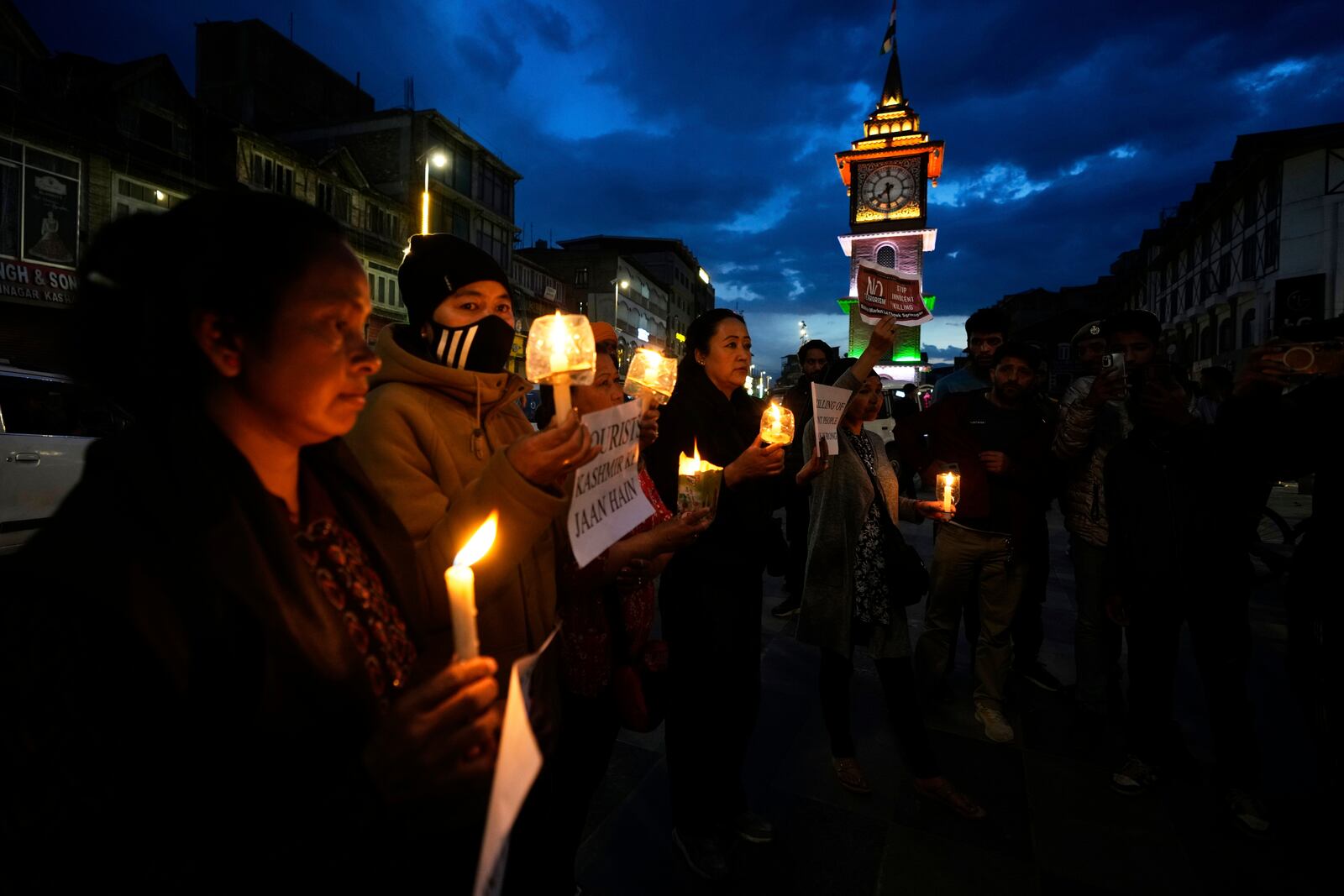 People hold candles during a candlelight protest in Srinagar, Indian controlled Kashmir, Wednesday, April 23, 2025, a day after an attack killed at least 26 people, most of them tourists. (AP Photo/Mukhtar Khan)