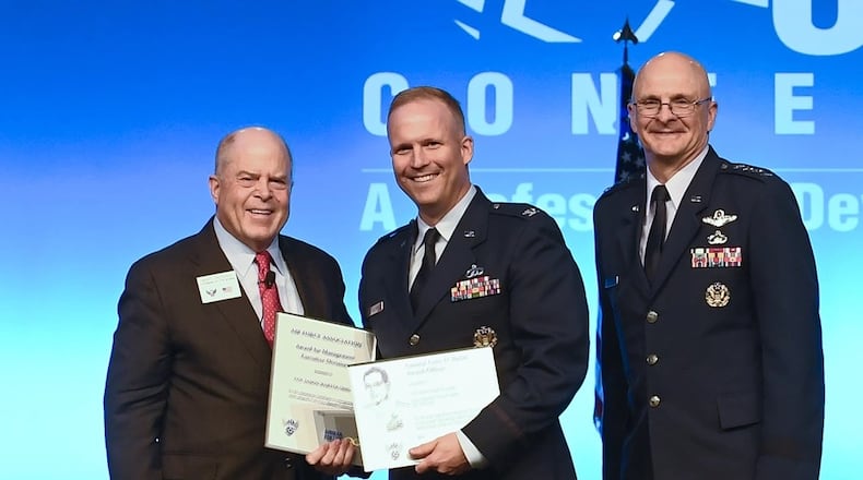 Then-Col. Jason Bartolomei, center, receives the Air Force Materiels Command Management and Gen. Larry D. Welch Award-Executive Division during the Air Force Association Air, Space and Cyber Conference in National Harbor, Md., in September 2019. U.S. Air Force photo by Andy Morataya.