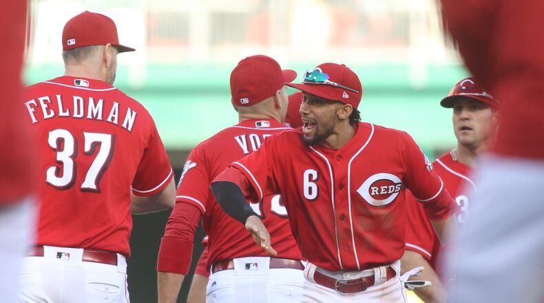 The Reds’ Billy Hamilton congratulates Scott Feldman after a victory against the Giants on Sunday, May 7, 2017, at Great American Ball Park in Cincinnati. David Jablonski/Staff
