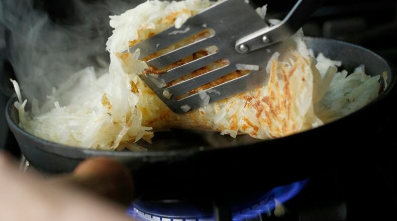 Potatoes are browned on a skillet to make hash browns Tuesday Jan. 12, 2016. Styled by Lisa Schumacher. (Michael Tercha/Chicago Tribune/TNS)
