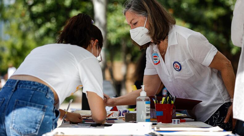 Sharon Alexander, Voter Services chair of the League of Women Voters of Chattanooga, helps a University of Tennessee student register to vote during a voter registration event put on by the League of Women Voters of Chattanooga in partnership with the UTC women, gender and sexuality studies program, and the student group MocsGoVote Tuesday, Sept. 28, 2021, in Chattanooga, Tenn. (Troy Stolt/Chattanooga Times Free Press via AP)