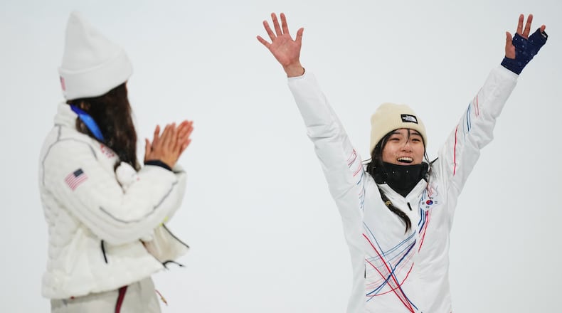 Silver medalist United States' Chloe Kim, left, claps as gold medalist South Korea's Choi Ga-on celebrates winning the the women's snowboarding halfpipe finals at the 2026 Winter Olympics, in Livigno, Italy, Thursday, Feb. 12, 2026. (AP Photo/Abbie Parr)