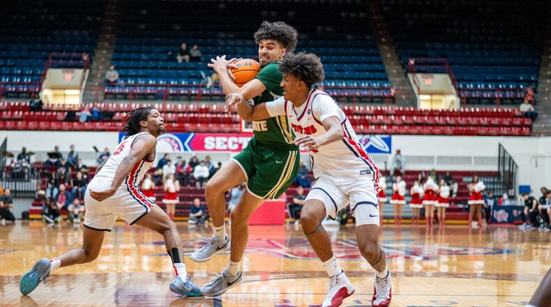 Wright State's Drey Carter drives against a pair of Detroit Mercy defenders during a game earlier this season. Wright State Athletics photo