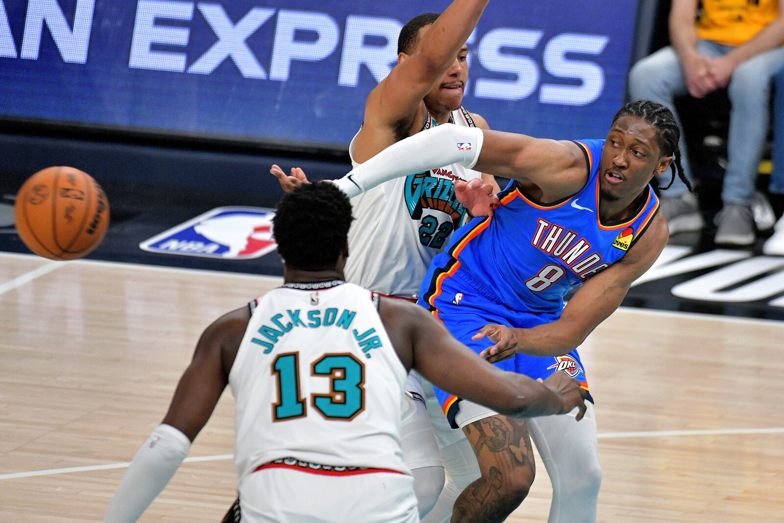 Oklahoma City Thunder forward Jalen Williams (8) passes the ball between Memphis Grizzlies guard Desmond Bane (22) and forward Jaren Jackson Jr. (13) in the second half of Game 3 of an NBA first-round playoff series Thursday, April 24, 2025, in Memphis, Tenn. (AP Photo/Brandon Dill)