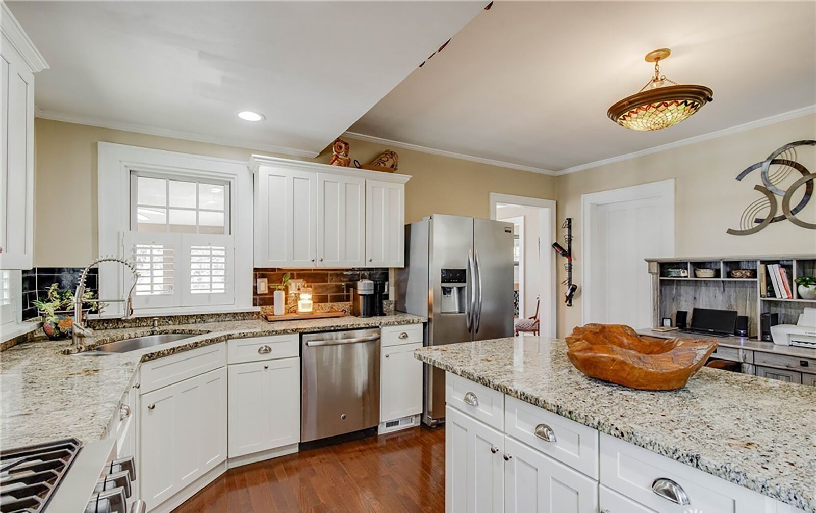 The remodeled kitchen has granite countertops, hardwood floors and stainless steel appliances.