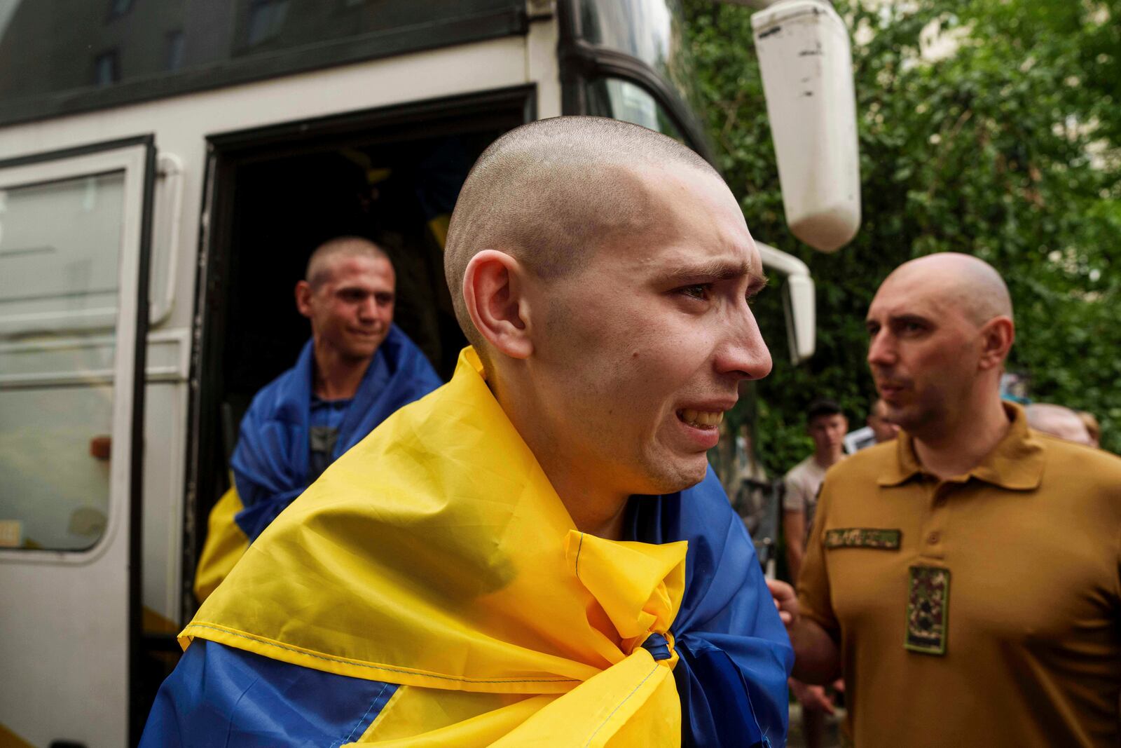 An Ukrainian soldier reacts after returning from captivity after a POWs exchange between Russia and Ukraine, in Chernyhiv region, Ukraine, Monday, June 9, 2025. (AP Photo/Evgeniy Maloletka)