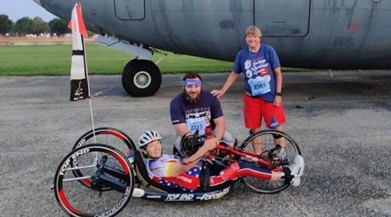 Holly Koester in her hand cycle and her twin sister Joy and their nephew Jared at the U.S, Air Force Marathon in 2022. Holly competed in the marathon —she has competed in all of them but one since the race began in 1997 – while Joy and Jared did the half marathon. Holly was a captain in the Army when she was paralyzed in an auto accident as she was preparing to deploy to Desert Storm.  Since her injury she has competed in 174 marathons and has already completed  the 50 states/ 50 marathons challenge once and is well on her way to  it again. She was inducted in the Ohio Veterans Hall of Fame in 2017, has been active in the Buckeye chapter of the Paralyzed Veterans of American for over 30 years and still works as a substitute teacher just outside of Cleveland. CONTRIBUTED
