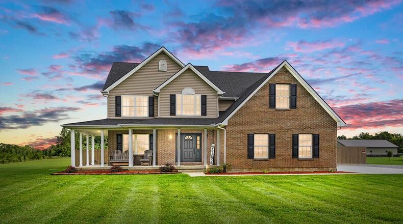 The front of the home has a wraparound covered front porch and brick-and-vinyl exterior. There is also a two-car attached, side-entry garage. CONTRIBUTED