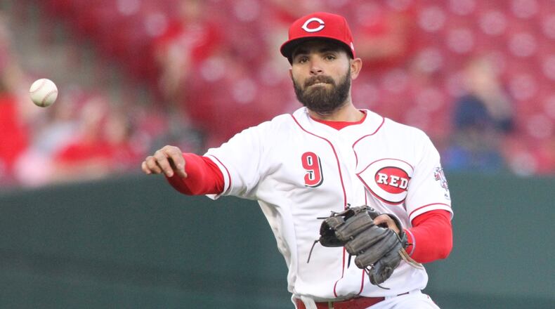Reds shortstop Jose Peraza throws to first base for an out against the Cardinals on Thursday, April 12, 2018, at Great American Ball Park in Cincinnati. David Jablonski/Staff