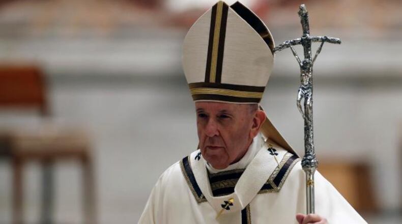 Pope Francis leaves at the end of a solemn Easter vigil ceremony in St. Peter's Basilica empty of the faithful following Italy's ban on gatherings to contain coronavirus contagion, at the Vatican, Saturday, April 11, 2020.