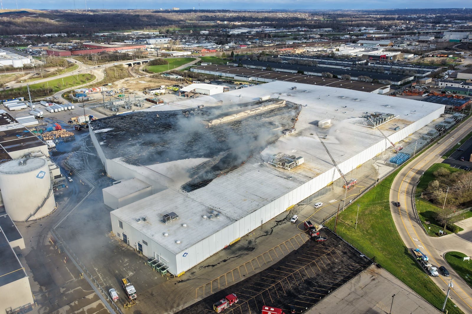 Morning crews work to extinguish remaining flames at the Fuyao Glass America plant in Moraine following a large fire. NICK GRAHAM / STAFF