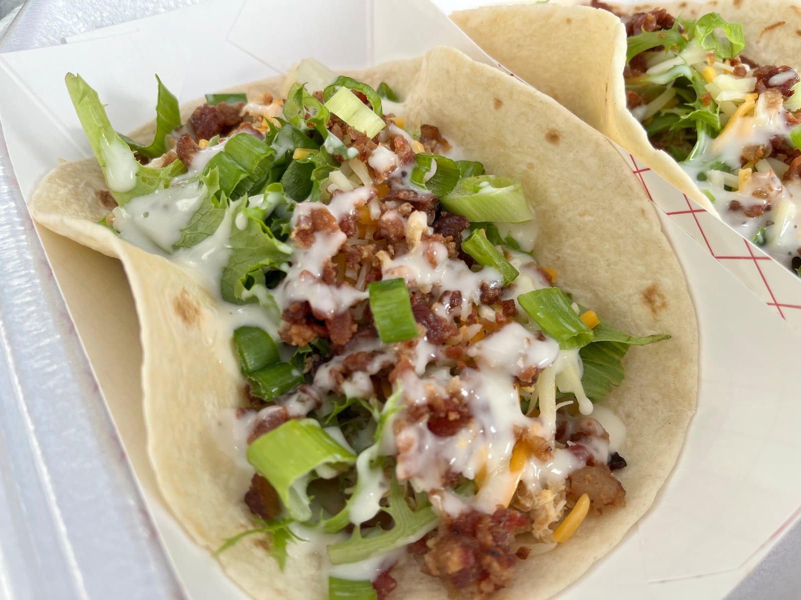Just over a dozen food trucks on Saturday, Aug. 3, 2024 put their spin on what it means to have bacon at the forefront during Bacon Fest at the Fraze Pavilion in Kettering. NATALIE JONES/STAFF