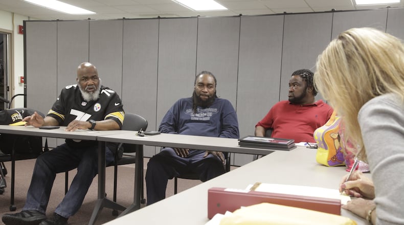 Dayton Det. Patty Tackett, right, meets with family members of Lillie Oglesby, who was brutally murdered in her home on May 26, 2004. Tackett is taking a fresh look at the unsolved murder. BYRON STIRSMAN/PHOTO.